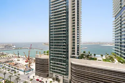 an aerial view of two tall buildings next to the ocean at Silkhaus Sea & Palm View 1BDR in Marina Vista in Dubai