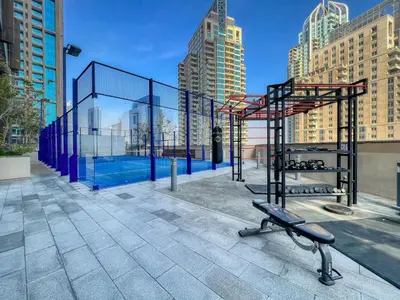 a batting cage with a bench in a city at Luxury 1BR Apartment in Dubai Marina Gate in Dubai
