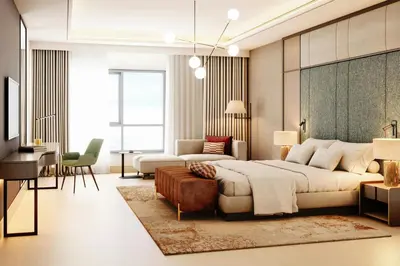 a bedroom with a large bed and a living room at Marriott Hotel Production City, Dubai in Dubai
