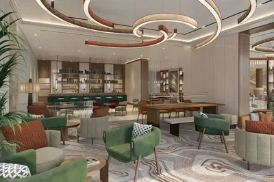 a lobby of a hotel with chairs and tables at Marriott Hotel Production City, Dubai in Dubai