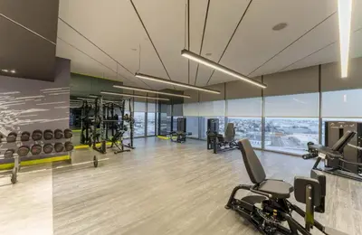 a gym with treadmills and exercise equipment in a building at Aykon Luxury Sky Collection Suites with Balcony & Sea View by HSHOME in Dubai