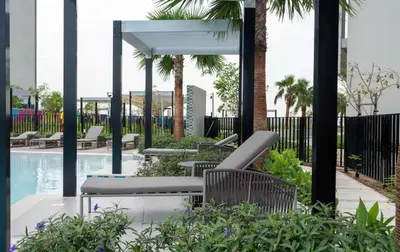 a patio with chairs and a swimming pool at Aykon Luxury Sky Collection Suites with Balcony & Sea View by HSHOME in Dubai