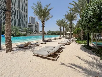a beach with lounge chairs and a swimming pool at Frank Porter - Bayshore at Creek Beach in Dubai