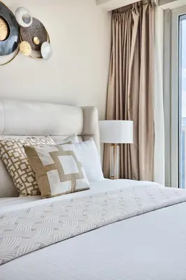 a bedroom with a white bed and a window at Frank Porter - Emaar Residences Dubai Marina in Dubai