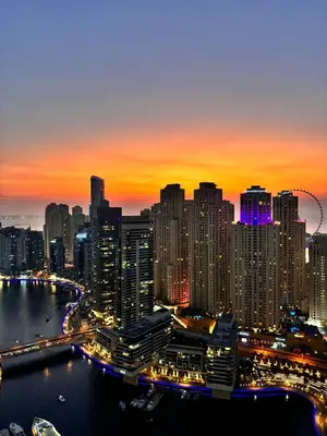 a city skyline at night with a river and buildings at Frank Porter - Emaar Residences Dubai Marina in Dubai