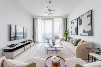 a living room with a couch and a table at 2BR Beachfront Gem with Dazzling Views of the Palm in Dubai