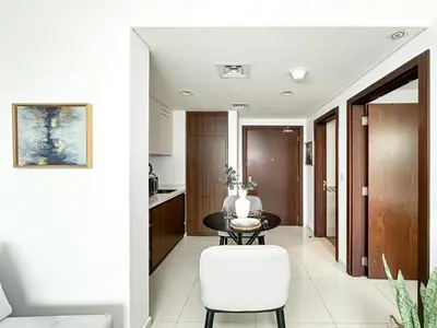 a kitchen and dining room with a table and chairs at Trophy - Springs Suite with Cozy Balcony Garden in Dubai
