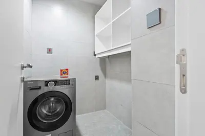 a washer and dryer in a small bathroom at Whole 3 BR with Maids Room House - The Springs - Privat Garden in Dubai