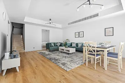 a living room with a table and a couch at Whole 3 BR with Maids Room House - The Springs - Privat Garden in Dubai
