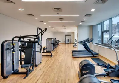 a gym with several treadmills and cardio machines at Dubaiashome - Luxury Special Stay in Dubai