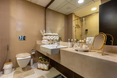 a bathroom with a sink and a toilet and a mirror at Dubaiashome - Luxury Special Stay in Dubai