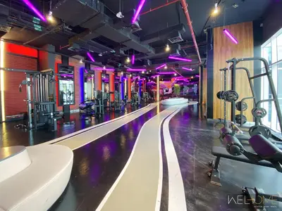 a fitness room with a gym with purple lights at WelHome - Relaxing and Fancy Studio Apt with City View in Dubai