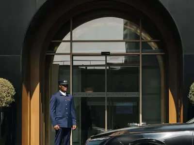 a man in uniform standing in front of a building at Pullman Dubai Jumeirah Lakes Towers in Dubai
