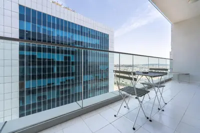a balcony with a table and chair on a building at Marco Polo - Modern 1BR in Business Bay near Burj Khalifa in Dubai