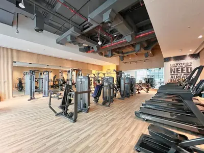 a gym with rows of treadmills and machines at The Smart Concierge - Seven Palm in Dubai