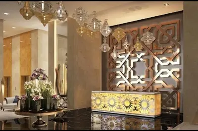 a lobby with a counter with flowers on it at Ghalia Studio Apartment in Dubai