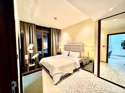 a bedroom with a large bed and a glass door at Dubai Marina Gate 1 Deluxe in Dubai