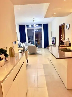 a living room with a kitchen and a living room with a couch at Dubai Marina Gate 1 Deluxe in Dubai
