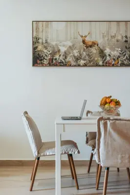 a dining room table with a laptop on it at VESTA - Dubai Residence in Dubai