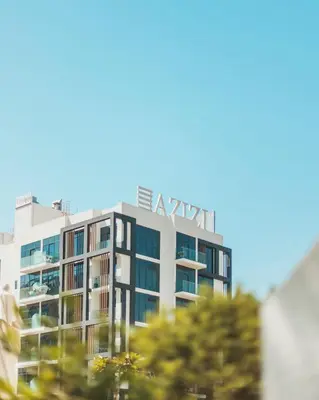 a tall building with a sign on top of it at VESTA - Dubai Residence in Dubai