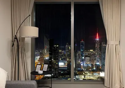 a room with a window with a view of a city at Luxury 2 BR Apartment, 5 Mins to Dubai Mall with Amazing view in DownTown Views 2 in Dubai