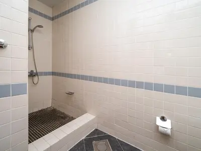 a bathroom with a shower and a toilet at Spacious 2 Bedroom Apartment in Tecom in Dubai
