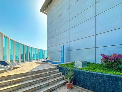 a building with stairs in front of a building at Spacious 2 Bedroom Apartment in Tecom in Dubai