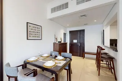 a dining room with a table and chairs at Silverene Tower B - Exciting Two Bedroom in Dubai