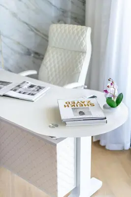 a white table with a book and a magazine on it at GuestReady - Luxurious living with sea view in Dubai
