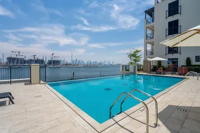 a swimming pool with a view of the city at GuestReady - Luxurious living with sea view in Dubai