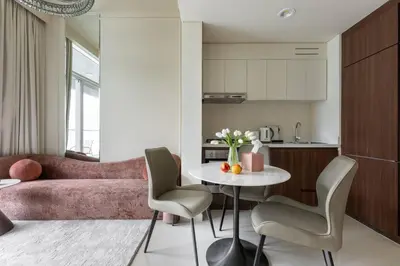 a kitchen and a living room with a table and chairs at Glamorous 1Bedroom in Business bay l Large Balcony in Dubai