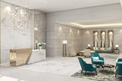 a lobby with blue chairs and a reception desk at Glamorous 1Bedroom in Business bay l Large Balcony in Dubai