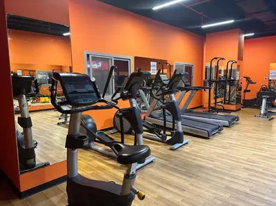 a gym with several tread machines in a room at Cozy Studio- Dubai Marina in Dubai