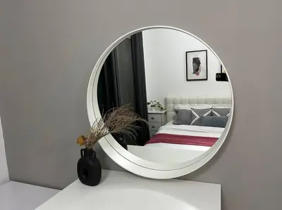 a round mirror in a bedroom with a bed at Cozy Studio- Dubai Marina in Dubai