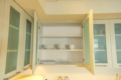 a kitchen cabinet with bowls and dishes in it at Downtown Oasis Luxury One-bed in Downtown Dubai in Dubai