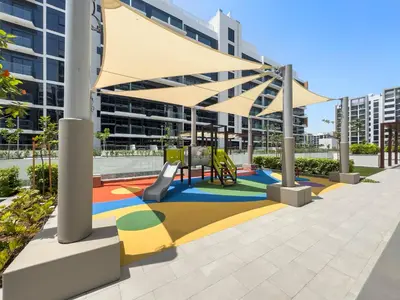 a playground in a building with awning at Beautiful 1 BR with Gym, Pool & Kid's Playground in Dubai