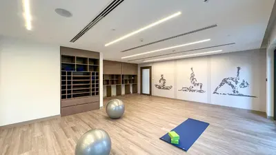 an empty room with a yoga studio with a yoga mat at Stunning 2BR Full Burj Khalifa Views 5min walk to Dubai Mall in Dubai