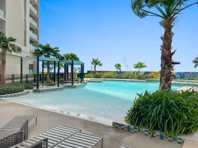 a swimming pool with a gazebo and palm trees at Silkhaus New High Floor Studio In Business Bay in Dubai