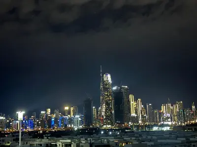 a night view of a city with lit up buildings at Modern studio view Burj Khalifa in Dubai