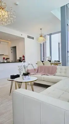 a living room with a white couch and a table at Spectacular Lagoon Apartment in Dubai