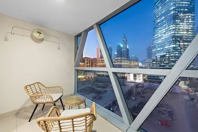 a room with a large window with a view of the city at First Class 1BR Modern & Stylish Living in Dubai