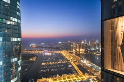 an aerial view of a city at night at Dubai 2BR Flat, Marina Views, Pool Access, Parking, Walk to Mall in Dubai