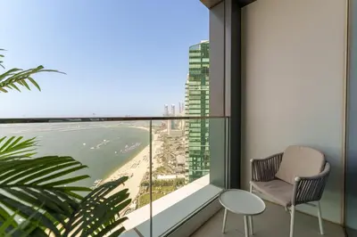 a balcony with a chair and a view of the ocean at Maison Privee - Luxury Living w/ Superb Sea Views in Address JBR in Dubai