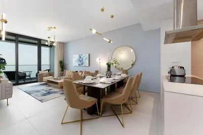 a dining room and living room with a table and chairs at Maison Privee - Luxury Living w/ Superb Sea Views in Address JBR in Dubai