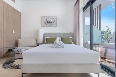 a bedroom with a large white bed and a couch at Lux Stu Bright Urban Escape Stay Near Downtown in Dubai