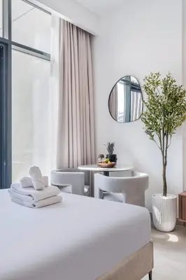 a bedroom with a bed and a table and chairs at Lux Stu Bright Urban Escape Stay Near Downtown in Dubai