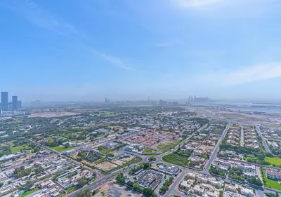 an aerial view of a city with buildings and the ocean at Downtown Views 4702 in Dubai