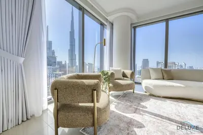 a living room with a couch and chairs and windows at Luxurious 2BR Apartment at Boulevard Point Downtown Dubai by Deluxe Holiday Homes in Dubai