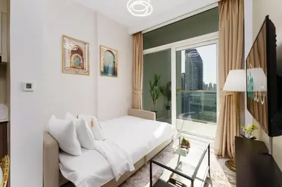 a bedroom with a bed and a large window at Contemporary Apartment with Burj Khalifa View in Dubai