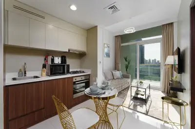 a kitchen and living room with a table and chairs at Contemporary Apartment with Burj Khalifa View in Dubai